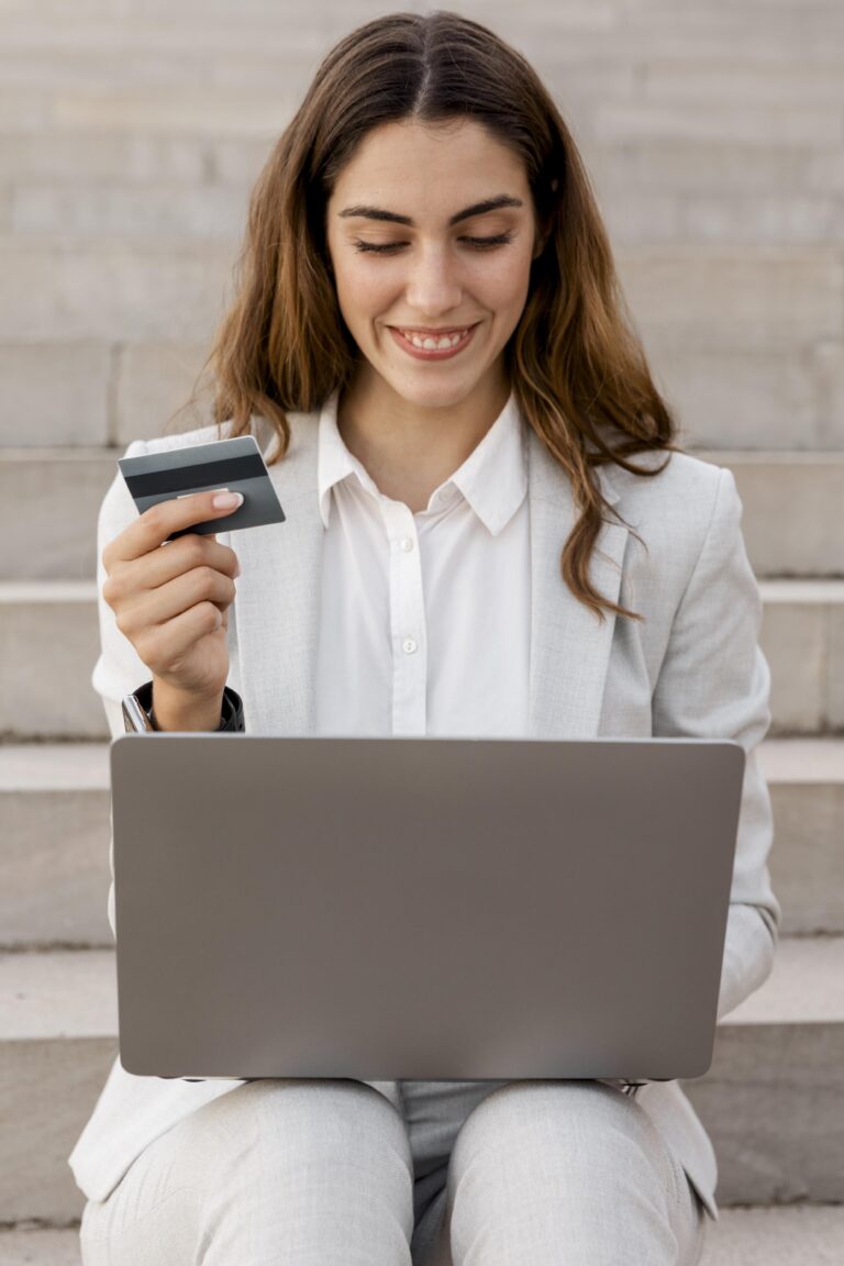 smiley-businesswoman-shopping-online-with-laptop-credit-card