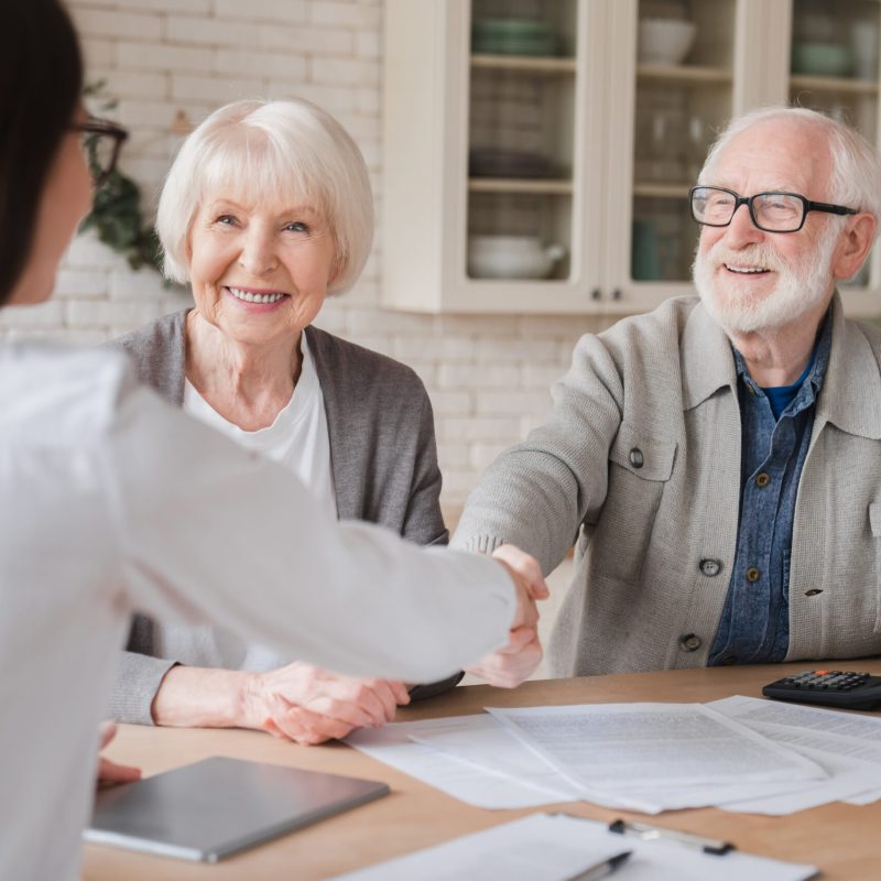 Happy old elderly senior grandparents family couple clients signs financial insurance, pension, startup, dealing handshake agent lawyer, agreement with customers on investment contract, bank manager